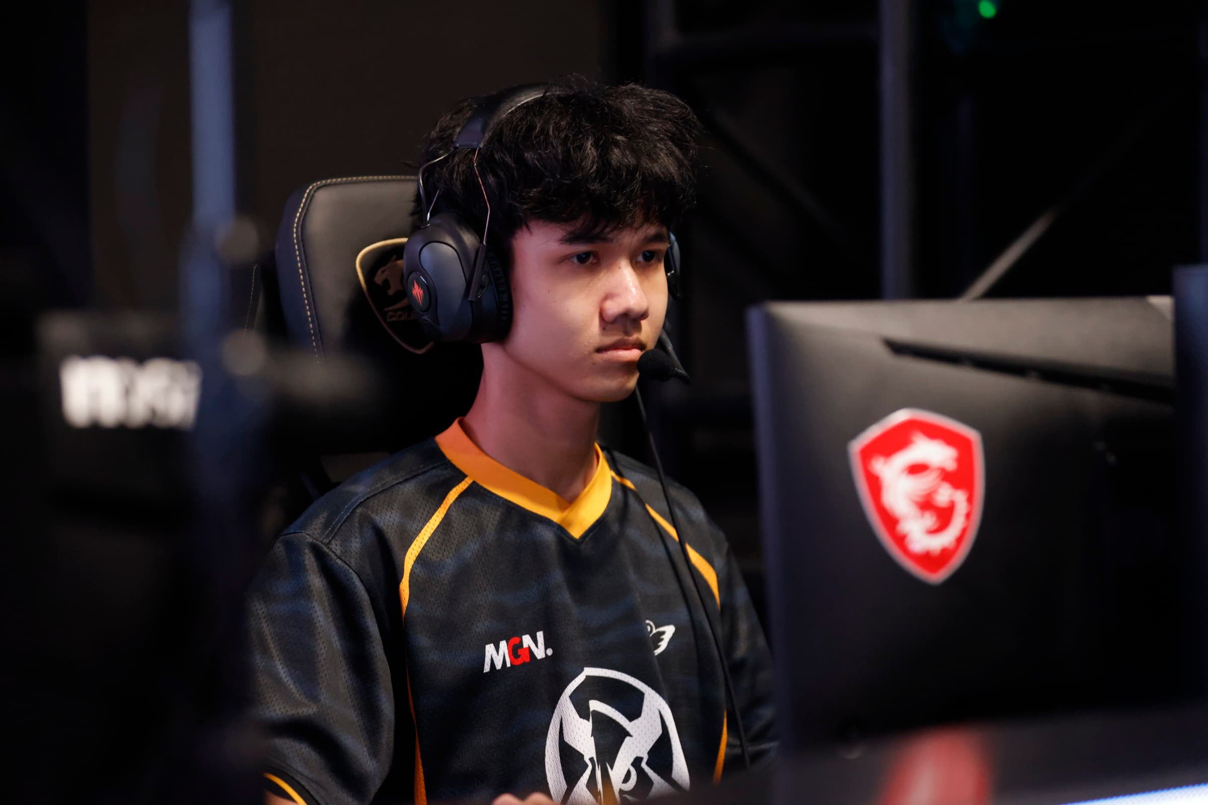 LCP 賽事選手在 MSI 對戰設備前，戴耳機專注比賽中